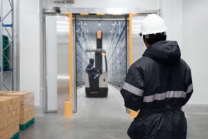 men in hallway of cold storage